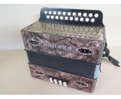 A Hohner D/G button accordian 
Condition report:  In playable condition 