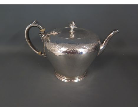 An early Victorian silver teapot of inverted pear form with cross hatch and scroll detailing and acorn finial - London 1837 -