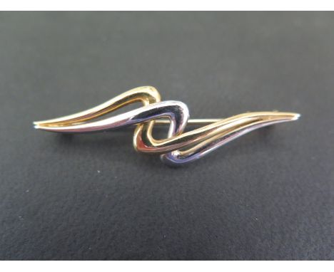 A bi-colour zig-zag bar brooch - Tests as 9ct gold - Length 4.8cms - Weight approx 3.7gms
Condition Report: Good - With light