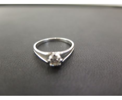 An 18ct gold diamond single-stone ring - The brilliant-cut diamond to the tapered grooved shoulders and band - Estimated diam