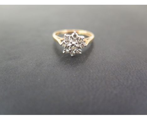 An 18ct gold brilliant-cut diamond cluster ring - Diamond weight 0.50ct, stamped to band - Hallmark partially obscured - Ring