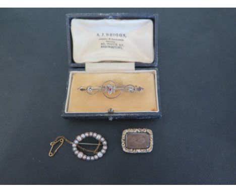 A late 19th/early 20th century gold oval seed pearl brooch - Width 2.5cms - A memorial brooch with woven hair panel and rever