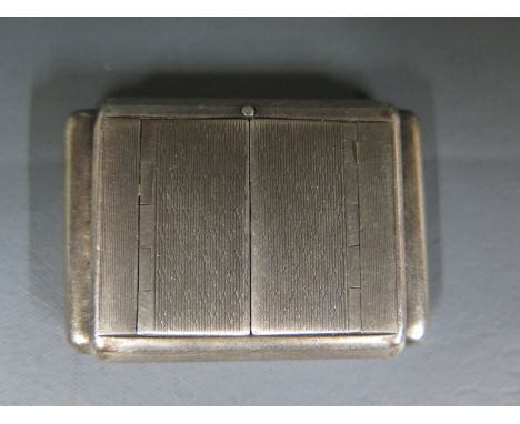 A silver cased Dunhill purse watch of Art Deco form with squeeze action, hinged doors and engine turned decoration square whi