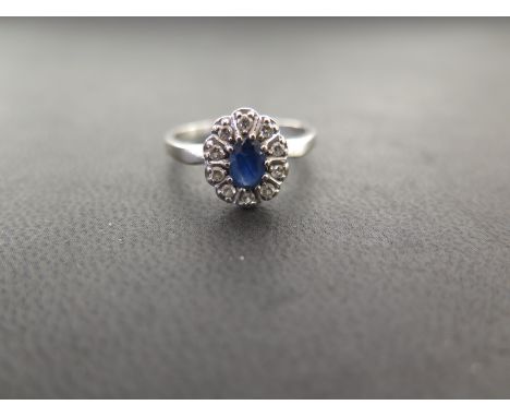 An 18ct gold sapphire an diamond cluster ring - Partial convention mark - Ring size S - Weight approx 3.6gms
Condition Report