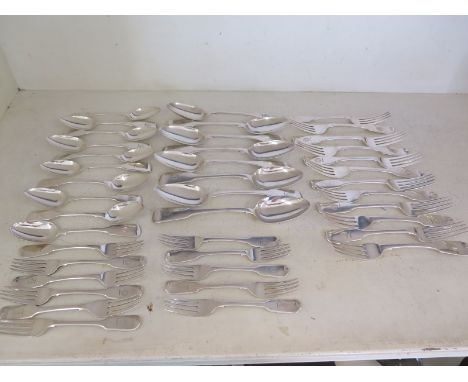A quantity of silver flatware including six fiddleback dessert spoons, five fiddleback dinner forks, two serving spoons Dubli