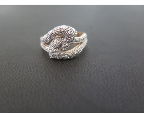 A 9ct gold single-cut diamond dress ring - Of intertwined design - Hallmarked London - Ring size P - Weight approx 3.7gms
Con