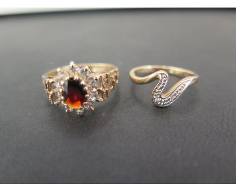 Two 9ct gold rings - To include a garnet and white-gem cluster - Size U - Together with a 'squiggle' ring set with two white 