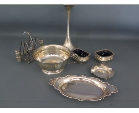 A Finnish silver candlestick marked 830 1992 with flared base and top, filled, a sterling silver toast rack with condiment se