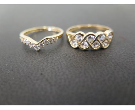 Two 14ct gold cubic zirconia dress rings - To include a cubic zirconia chevron ring - Together with a two-row band ring - Hal