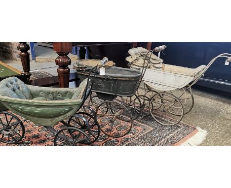 Three late 19th, early 20th century dolls prams with turned wooden and ceramic handles on metal frames and wheels. (3) (B.P. 