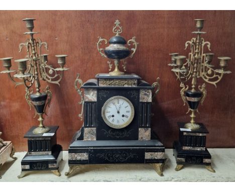 20th century black slate and marble architectural clock garniture, the clock with yellow metal mounts and two handled urn fin