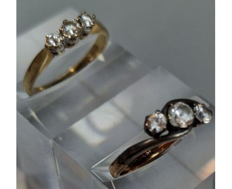 9ct gold three stone diamond ring, together with a silver twist shank three clear stone ring. The diamond ring 2g approx. Siz