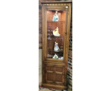 Vintage elm Ercol glazed display cabinet together with a matching Ercol elm glazed corner cabinet. (2) (B.P. 21% + VAT)