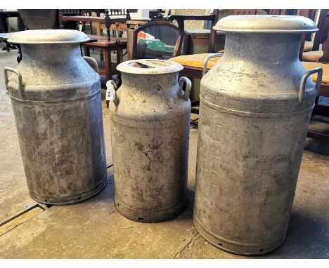 Three vintage aluminium milk churns, Old Castle Farm Neath, Torrington and the other marked MMB (Milk Marketing Board). (3) (