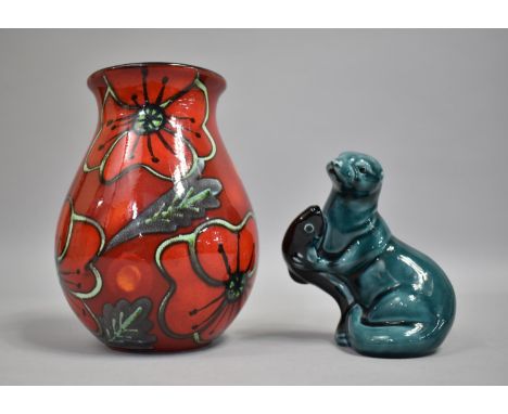 A Poole Delphis Vase and a Poole Otter with Fish, Vase 17cms High 