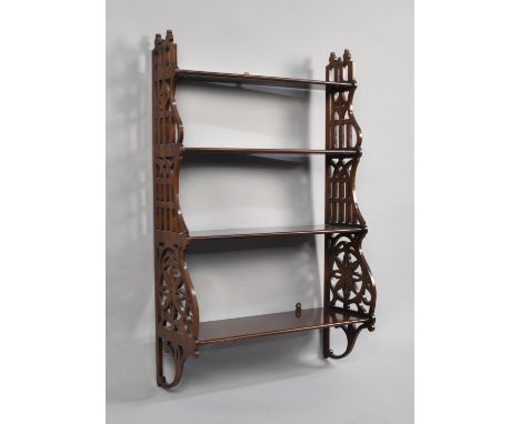 A Reproduction Mahogany Four Shelf Waterfall Wall Hanging Unit with Pierced Supports, 51cms Wide 