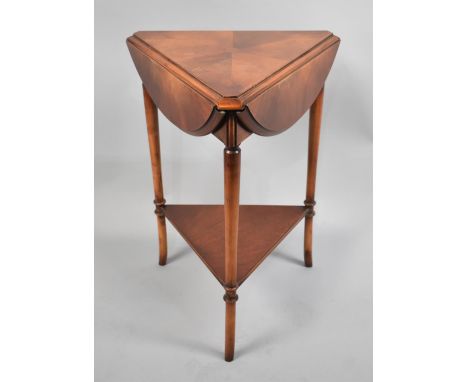 A Modern Reproduction Yew Wood Drop Leaf Triangular Table with Stretcher Shelf, 63cms High 