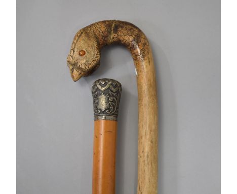 A Malacca Walking Cane with White Metal Handle together with a Novelty Walking Stick, The Handle in the Form of a Cock Pheasa