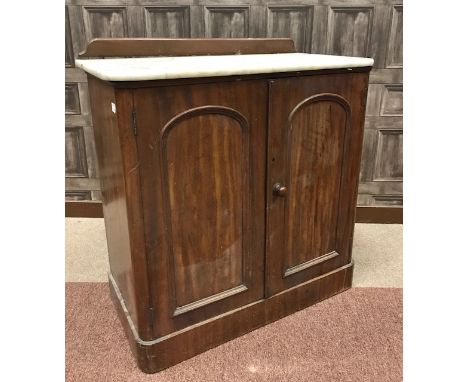 VICTORIAN MAHOGANY WASHSTANDthe white marble top with low raised back cupboard below enclosed by two arch moulded panel doors