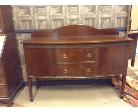 MAHOGANY BOW FRONT SIDEBOARD OF GEORGE III DESOGNwith blind fretted frieze, two central drawers, flanked by two cupboards, on