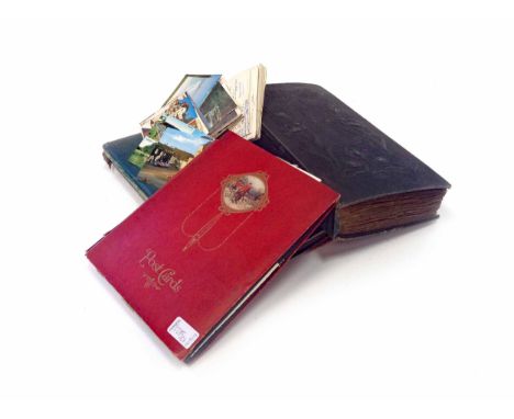 THREE ALBUMS OF VINTAGE POSTCARDSincluding many late 19th and early 20th century examples, with a number chromolithographic p