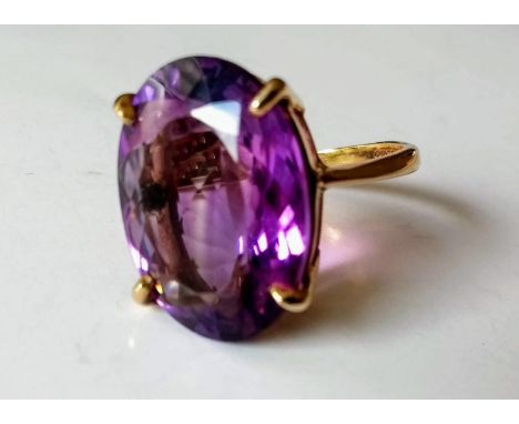 A 9ct yellow gold oval amethyst ring on a double bezel coronet, 19.79 x 14.7 x 7.84mm, 19.24 carat stone, hallmarked, size Q,