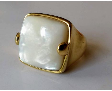 An 18ct yellow gold mother-of-pearl ring: the cushion-shape cabochon 17.4mm 17.5mm x 6.07mm, Italian 750 control marks, size 