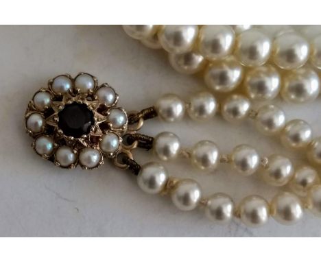 A vintage three-row graduated pearl choker necklace with ruby-set 9ct gold clasp, a similar Art Deco double row pearl necklac
