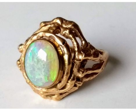 A contemporary gold ring with oval opal, size R, stamped 9ct, 6.81g 