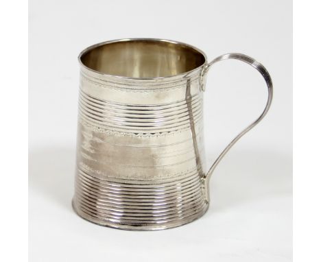 A George III silver mug, Peter & Ann Bateman, London 1792, of tapering form with reeded handle and bands inscribed beneath, 7