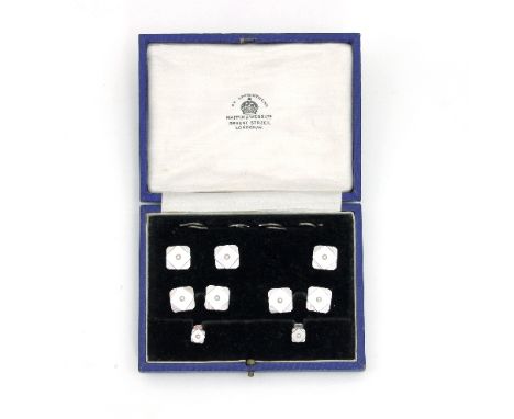 A gentleman's mother-of-pearl dress set, each piece centred by a seed pearl and set in 9ct white gold, (one button missing), 