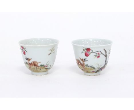 A pair of Chinese famille rose tea bowls, painted with deer amongst peach trees, bearing Guangxu reign marks Condition Report