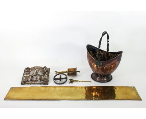 A 19th Century brass rotary spit, with iron hanging device and brass wall attachment, a carved wooden plaque of a figural mas