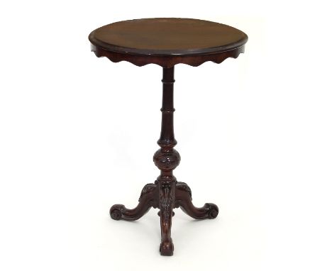 A late 19th Century tripod table with shaped apron on a turned column with carved knop on carved scroll cabriole legs, 54cm w