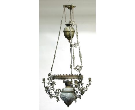 A hanging oil lamp, the ceramic reservoir embossed groups of putti and supported on three pierced embossed brackets to a circ