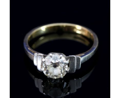 A diamond solitaire ring with stepped shoulders and platinum and gold shank