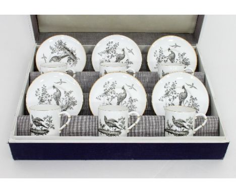 A Royal Worcester coffee service in the Aesthetic taste, comprising six cans and saucers, decorated en grisaille with a ho-ho