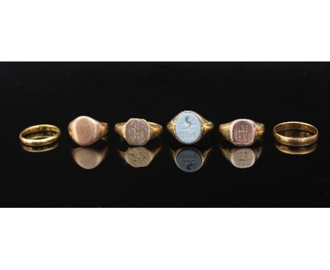 Two 22ct gold wedding bands, approximately 5.3gm, three 9ct gold signet rings, approximately 10.8gm and a signet ring with ca