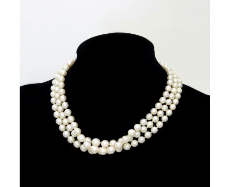 A three-row cultured pearl necklace, the rows of graduated pearls to a pearl cluster clasp set in 9ct gold