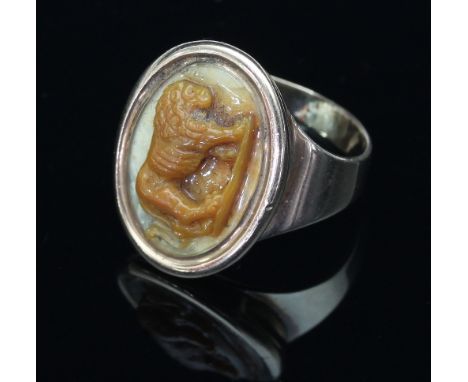 An early 19th Century hardstone cameo ring, the oval plaque depicting a standing lion in profile