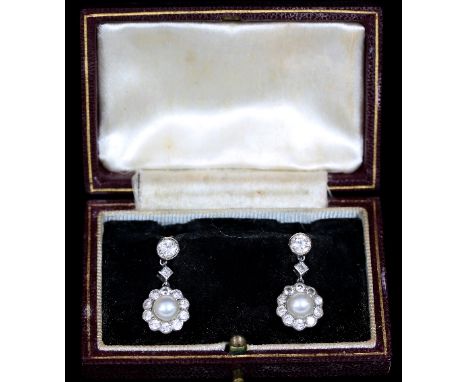 A pair of pearl and diamond cluster ear pendants, each with central pearl to a border of ten diamonds suspended beneath a squ