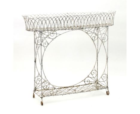 A painted wire jardinière stand, with oval upper section above a single open shelf with scroll corner detail, 104cm wide