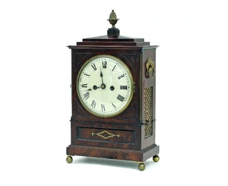 A Regency mahogany bracket clock, the case with gilt brass pineapple finial, fielded canted spandrels, brass diaper inlay and