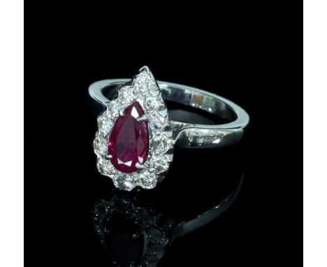 A ruby and diamond cluster ring, the pear-shaped ruby to a border of twelve diamonds, set in white metal, ring size L½
