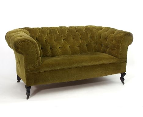 A two-seater button-back settee, upholstered in a dark green velvet, on cabriole legs with castors, 166cm wide Condition Repo