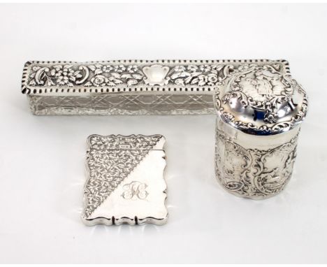 A silver tea caddy, William Comyns, London 1901, of cylinder form, the domed cover and sides decorated figures within scrolli