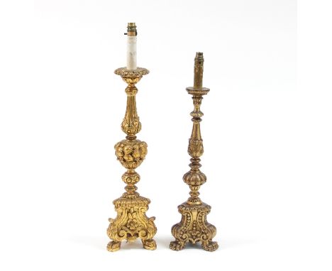 Two carved wood Italian style altar candlesticks, with turned baluster carved columns, one with acanthus leaves, one with fru