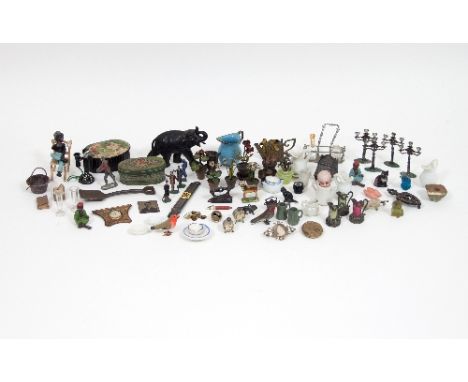 A quantity of various dolls house accessories to include a quantity of lead painted animals and plants, a set of four lead ca