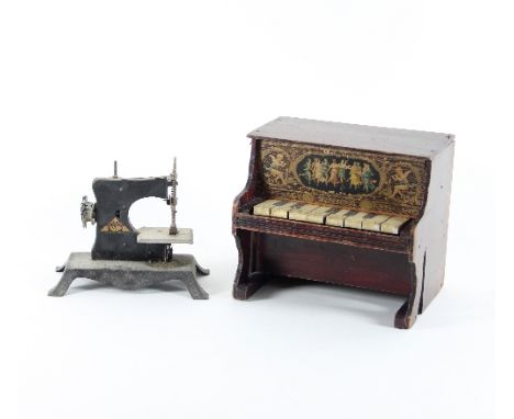 A child's toy piano and a child's sewing machine, the piano with keys playing an interior xylophone, 23cm wide, the metal sew