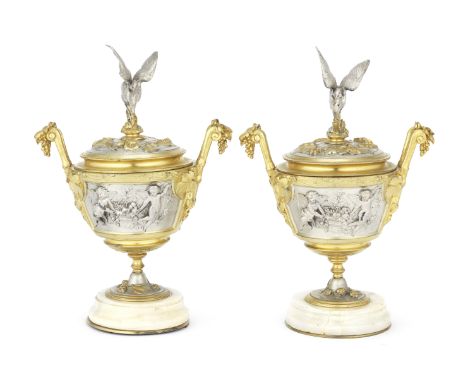 A pair of late 19th century / early 20th century French parcel gilt and silvered bronze and onyx garniture vasesof pedestal c